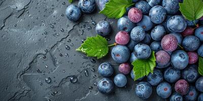 AI generated Blueberries with leaves on black stone background. Top view with copy space photo