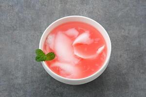 Es Kelapa Muda or young coconut ice with syrup photo