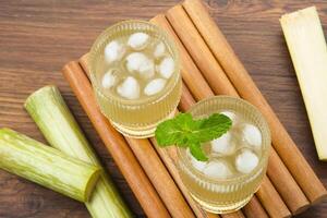 Fresh sugar cane juice or Es Tebu in glass. Indonesian drink. photo