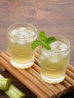 Fresh sugar cane juice or Es Tebu in glass. Indonesian drink. photo