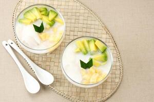 Es teler or es teller, Indonesian dessert, consist of avocado, young coconut, jackfruit, served with coconut milk or sweetened condensed milk. photo