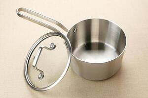 Stainless steel saucepan with glass lid photo