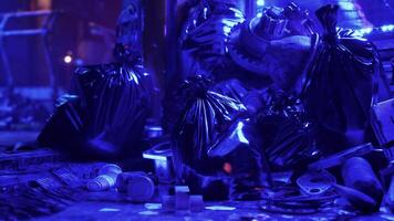 A Towering Heap of Discarded Waste Illuminated by Neon Lights on a Night Street video