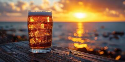 AI generated Glass of cola with ice cubes on the beach at sunset. photo