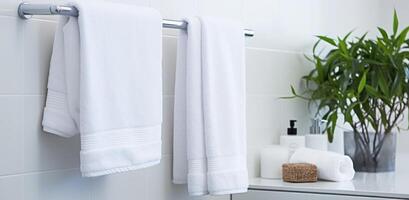 AI generated white towels hanging on a towel rack in a modern bathroom photo