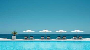 AI generated A minimalist shot of a poolside area with bright blue water, lounge chairs, and umbrellas photo