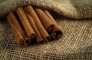 AI generated Cinnamon sticks on burlap fabric photo