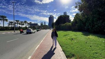 happy girl with long hair spins in the city with a view of high-rise buildings. High quality FullHD footage video