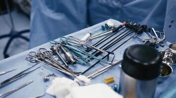 Medical instruments in steel tray on table for surgery. Preparing of surgical tools for a operation. Scalpels and forceps and tweezers. Surgery or emergency case and ambulance or treatment concept video