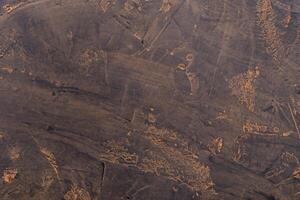 Abstract Composition, Dark Stone Surface with Traces of Cocoa Powder. photo