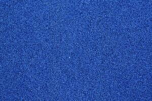 vibrante azul fútbol americano césped textura, cerca arriba Disparo con suave atención antecedentes foto