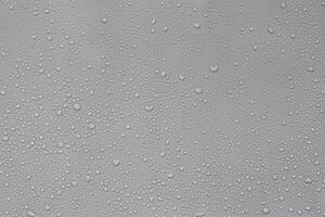 Urban Serenity, Raindrops on Car Hood Against Gray Background photo