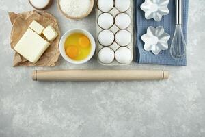 Ingredients and kitchen utensils for making homemade cakes. Home kitchen. Copy space. Flat lay. photo