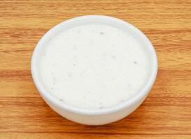 Fresh Raita with dahi or yoghurt served in a bowl isolated on grey background side view of indian, pakistani food photo