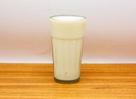 cold milk glass isolated on table top view of indian and pakistani spicy food photo