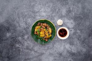 stir fried chicken heart and lungs with fish sauce served in bowl isolated on dark grey background top view of japanese food photo