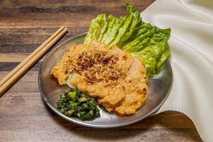 Crispy Fried Shrimp Cake with lettuce leaf, spring onion and chopsticks served in dish isolated on wooden table top view of hong kong fast food photo