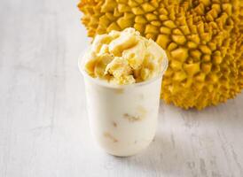 Fresh Durian Smoothie served in disposable glass isolated on background top view taiwan food photo