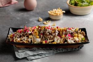 Chicken Shawarma Nachos served in dish isolated on table top view of arabic breakfast photo