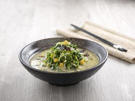 Poached Chinese Spinach with Egg Trio and Minced Pork with chopsticks served in a dish isolated on mat side view on grey background photo