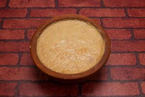 Mishti Doi or sweet yogurt served in plate isolated on background top view of bangladeshi dessert food photo
