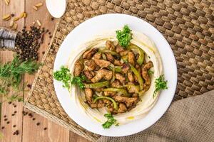 Chicken Hummus served in dish isolated on table side view of arabic photo