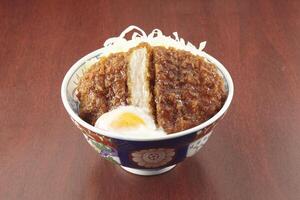 katsu don sauce served in a dish isolated on wooden table side view of singapore food photo