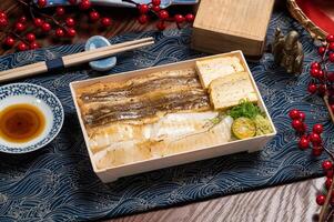 Eel fish star eel bowl in a dish with chopsticks isolated on mat side view of taiwan food photo