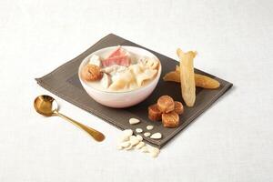 Golden Leg Apricot Juice Fish Maw Pig Lung Soup served in a dish isolated on napkin side view of hong kong food photo