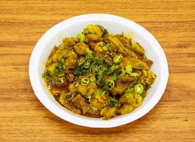 Chicken gobhi gosht served in plate isolated on table top view of indian and pakistani spicy food photo