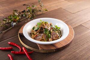 Spicy chilli Beef Show served dish isolated on wooden table top view of Hong Kong food photo