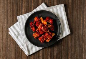 Homemade Spicy Korean fried chicken wings with sauce. Traditional Korean Food top view photo