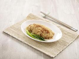 Shrimp Roe Noodle with chopsticks served in a dish isolated on mat side view on grey background photo