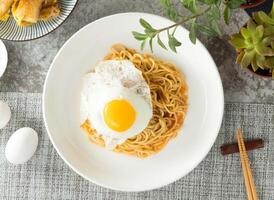 Mushroom Sizzling Noodles with sunny Egg served in dish isolated on napkin top view on table taiwan food photo