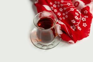Cup of apple tea isolated on colorful table cloth top view on grey background photo