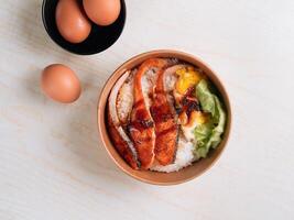 Salmon don with rice bowl, egg top view on grey background photo