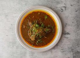 Spicy chicken qorma served in a plate isolated on background top view of indian and pakistani desi food photo