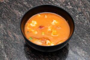 Thai soup served in bowl isolated on background top view of bangladesh and indian food photo