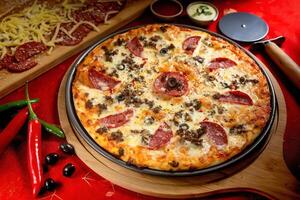 Beef Pepperoni pizza with tomato sauce and mayo isolated on wooden board top view of italian food on wooden background photo