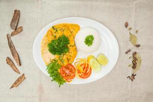 Machli methi malai curry or sweet fish curry, fish masala and fish karahi with rice served in a dish isolated on table top view of indian spices food photo
