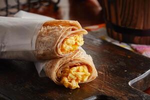 Egg Cheese Chapati Scrambled roll served in a dish isolated on wooden background side view photo