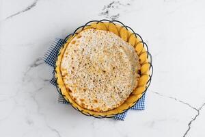 Punjabi breakfast naan kulcha in a basket isolated on napkin side view on grey background famous indian and pakistani food photo