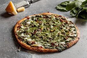 Spinach Bacon Pizza served in dish isolated on table top view of arabic breakfast photo