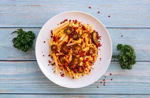 loaded Cheesy Fries Served in dish isolated on wooden table top view fastfood photo