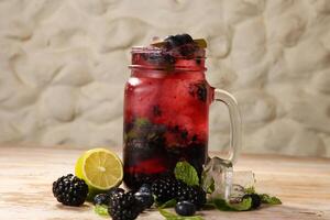 Arabic Style fresh mulberry and raspberry mojito fruit juices served in jar isolated on background top view drink photo