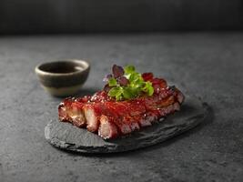 Roasted Honey BBQ Pork served in dish isolated on table top view of food photo
