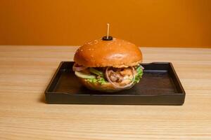 Beef Burger served in dish isolated on table top view of fastfood photo