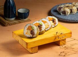 Japanese classic roll served isolated on wooden board top view of japanese food photo