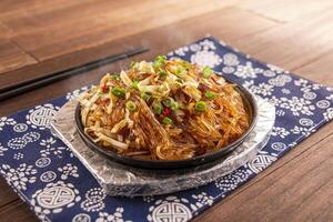 Sizzling Minced Meat Crystal Powder with noodles served dish isolated on wooden table top view of Hong Kong food photo