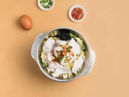 rebanado pescado Xiao pálido en un cuenco con sopa, chile salsa y primavera cebolla parte superior ver en de madera mesa foto